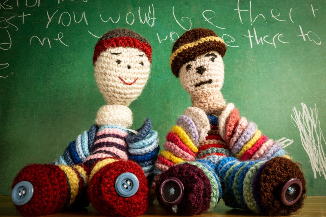 two crocheted toys sitting next to each other