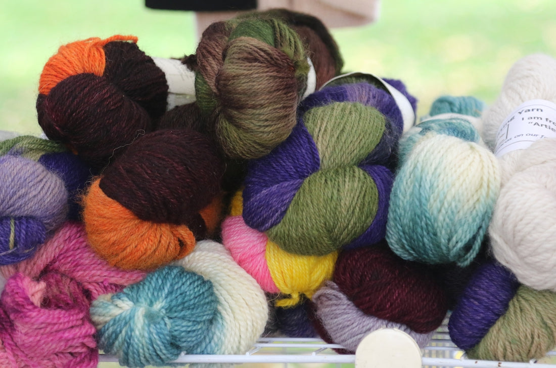 a pile of skeins of yarn sitting on top of a table
