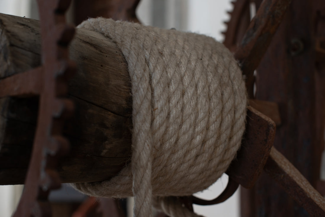 a close up of a rope on a wooden fence