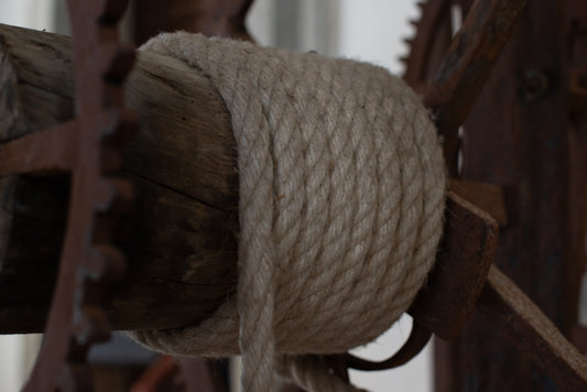 a close up of a rope on a wooden fence
